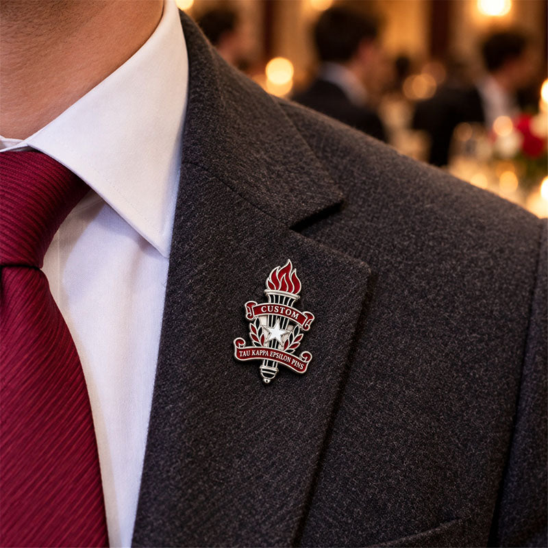 Custom Tau Kappa Epsilon pin worn on formal attire in a fraternity event setting