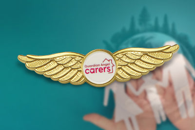 Custom Pilot Wings Pin Gold In Healthcare Industry Recognition Case With 3D Wings And Circular White Center Featuring Custom 'Guardian Angel carers' Text