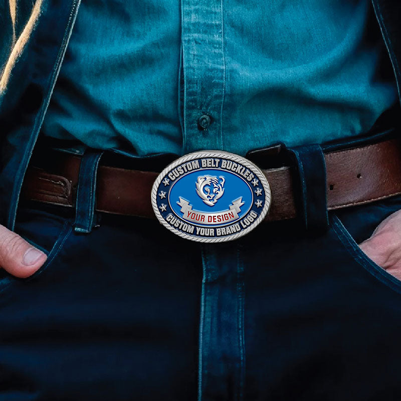 Custom oval belt buckle with blue enamel and silver tiger design, featuring custom text, worn on a man's waist