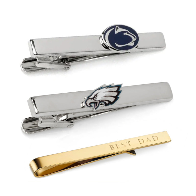 Collection of custom tie pins showing polished metal finishes, personalized designs, and formal accessory options