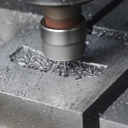 Advanced high-precision CNC engraving machine carving a detailed custom steel mold for metal badges, ensuring perfect replica of the custom design