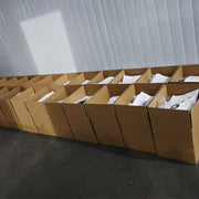Professional packaging process at Yearpins factory: Finished custom badges being carefully boxed for secure global shipping with free shipping worldwide