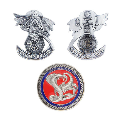 Three antique plating coins arranged in a triangle, featuring custom text and designs like a hooded figure with a scythe, wings, and serpents on silver coins with red and blue accents.