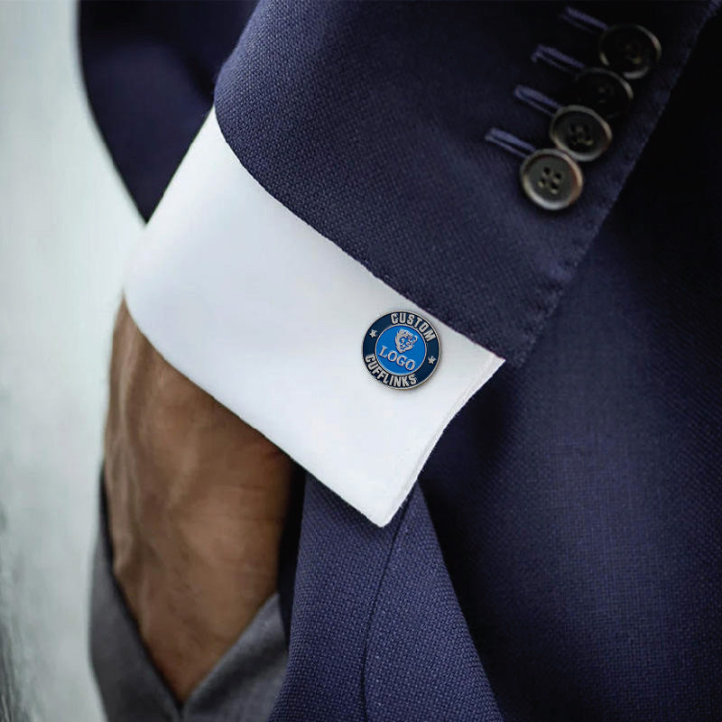 Custom cufflinks in dark blue with white text and emblem, shown worn on a dress shirt cuff in a professional close-up scene, featuring space for custom logo and text.