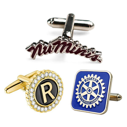 Display of custom cufflinks with three designs: silver with burgundy enamel and text, gold round with rhinestone border and initial, blue square with Rotary International emblem.