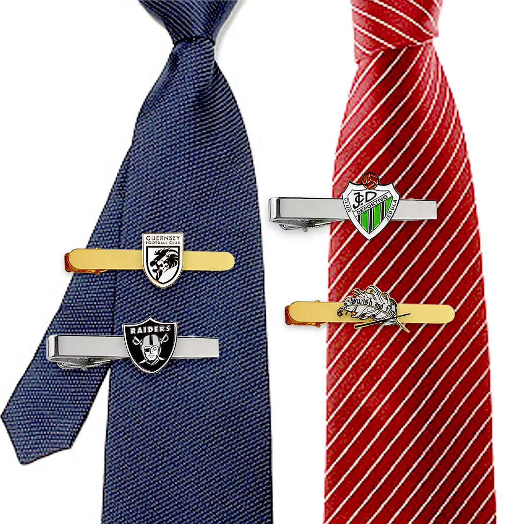 Display of custom tie clips on blue and red ties, featuring various emblem designs with custom text for professional business customization.