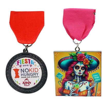 Custom Fiesta medals with UV printed, one featuring 'Fiesta 2016 No Kid Hungry' and the other a colorful skeleton design.