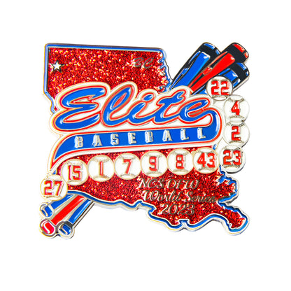 Custom baseball trading pin in the shape of Louisiana with red glitter, silver pinstripes, blue banner featuring "Elite" and "BASEBALL," mini baseballs with player numbers, crossed bats, and custom event text for the NCS OFIO World Series 2023.