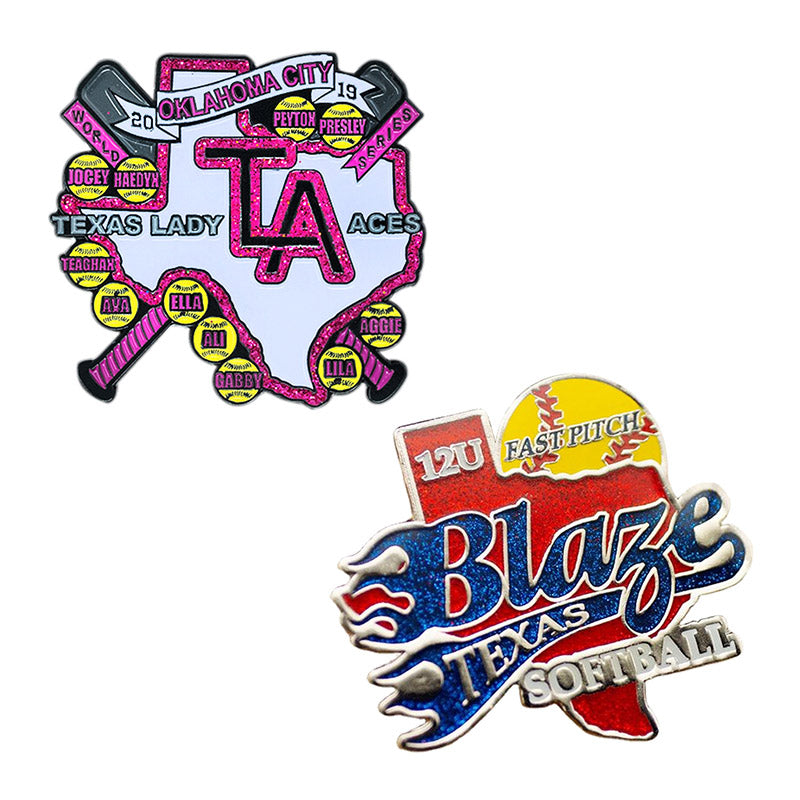 Two custom glitter softball trading pins: a pink Texas map with baseball bats and player names, and a yellow ball with a blue 'Blaze' design, featuring custom team and event text.