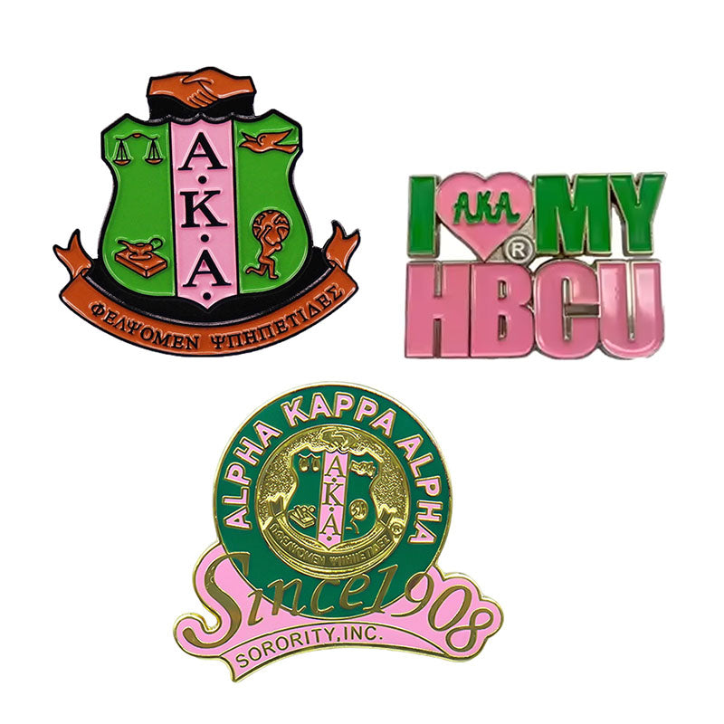 A collection of three custom Alpha Kappa Alpha pins, including an AKA crest design, 'I Love My HBCU' logo, and a 'Since 1908' anniversary pin.