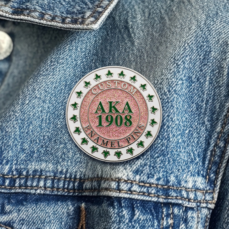 Alpha kappa alpa sorority sister lapel pins in silver finish worn on a blue denim jacket.