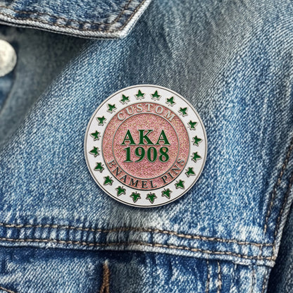 Alpha kappa alpa sorority sister lapel pins in silver finish worn on a blue denim jacket.