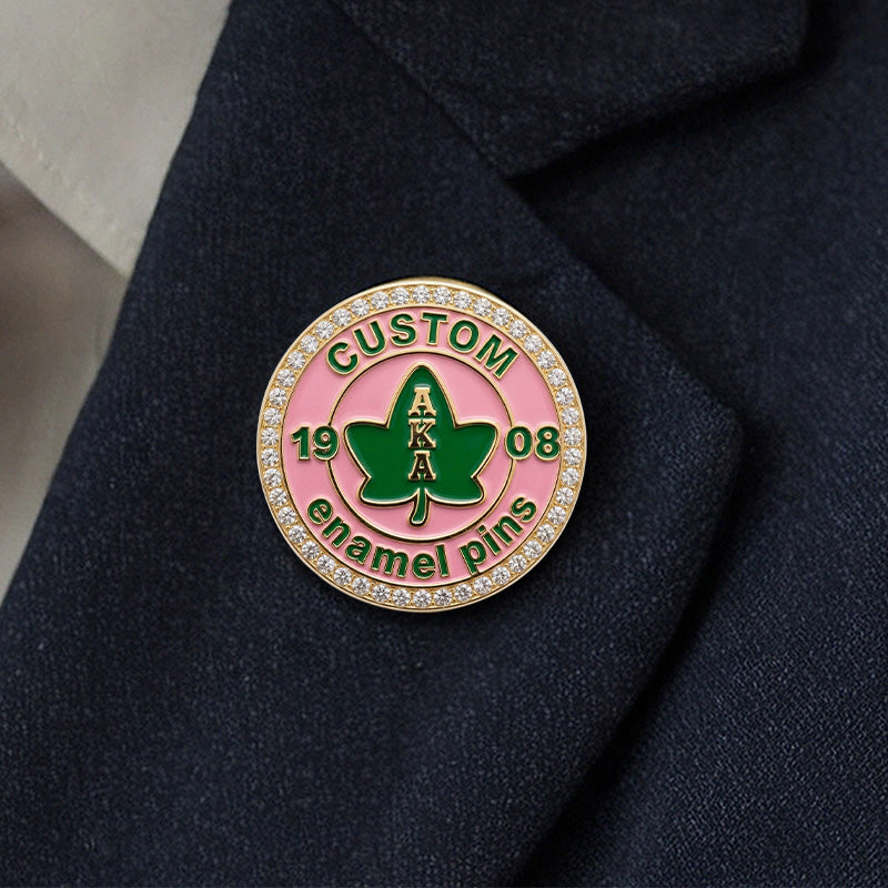 A custom Alpha Kappa Alpha sorority rhinestone pin worn on the lapel of a dark suit jacket.