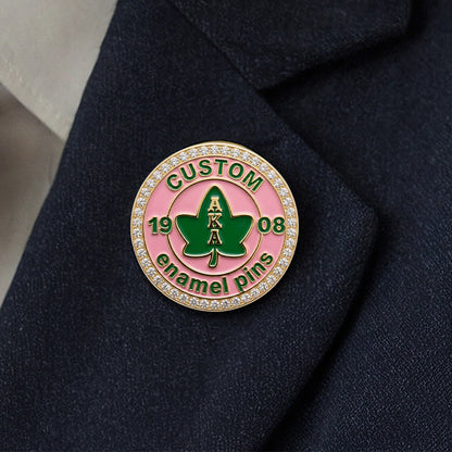 A custom Alpha Kappa Alpha sorority rhinestone pin worn on the lapel of a dark suit jacket.