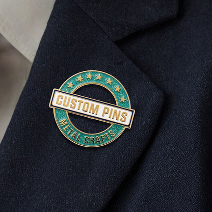 Custom enamel pins with glitter in Gold plating worn on a dark suit lapel for professional branding