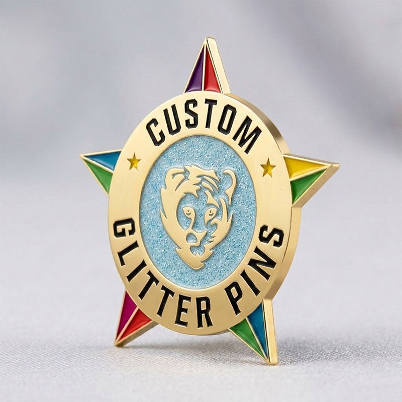 Custom enamel pins with glitter featuring Gold plating with a light blue sparkling star center and multi-color tips