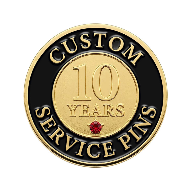 A custom round 10-year service recognition lapel pin in gold tone, featuring a smooth golden center with the number 10 and a small red rhinestone accent star, surrounded by a black enamel border with raised lettering.