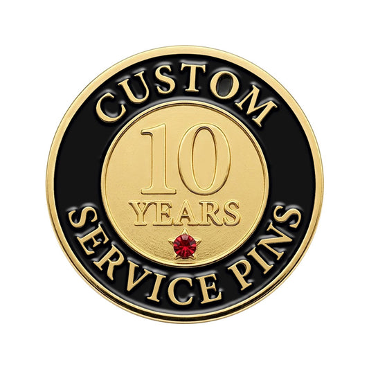 A custom round 10-year service recognition lapel pin in gold tone, featuring a smooth golden center with the number 10 and a small red rhinestone accent star, surrounded by a black enamel border with raised lettering.