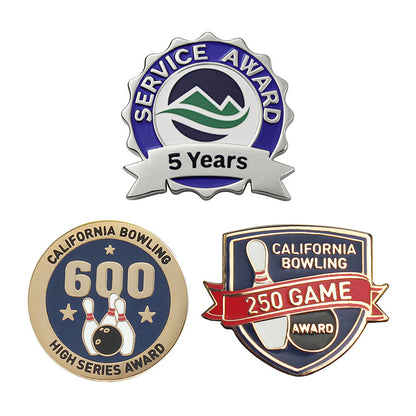 Three custom award pins: a scalloped "Service Award" pin with a 5 Years silver ribbon and green mountain logo, a round gold "California Bowling 600 High Series Award" pin, and a shield-shaped "California Bowling 250 Game Award" pin with a red ribbon banner.