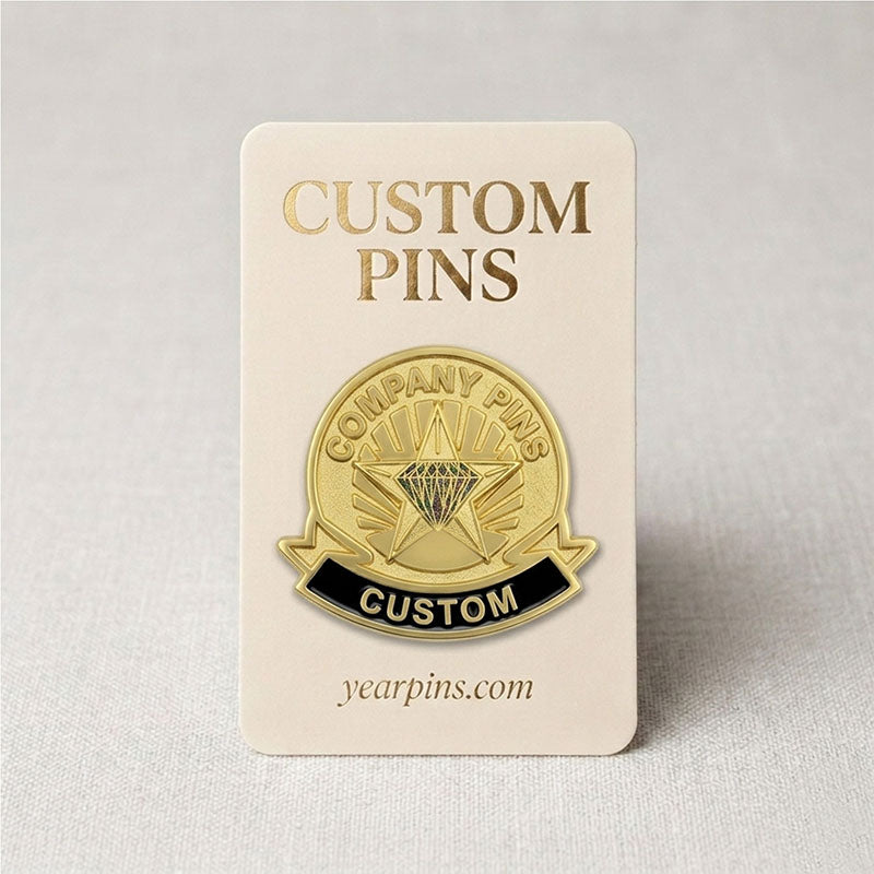 Custom gold tone company pin with a black enamel bottom ribbon displayed on a premium paper backing card for corporate gifts.