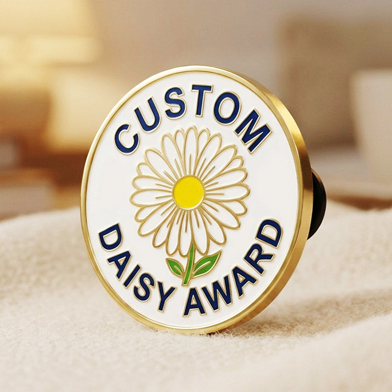 A side-angle perspective view of a round custom Daisy Award recognition lapel pin in gold tone