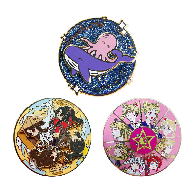 Three custom spinner pins featuring colorful anime designs, glitter effects, and rotating mechanisms.