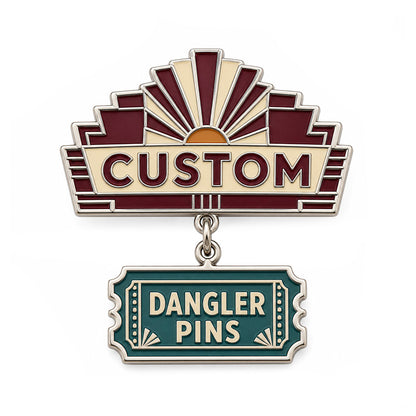 Silver custom dangler pin with burgundy sunburst and teal ticket charm