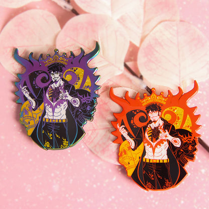 Custom glitter epoxy enamel pins in purple and orange, featuring a shifting multi-color iridescent metal finish and detailed anime character artwork.