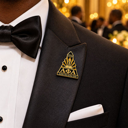 Custom Alpha Phi Alpha pin worn on formal attire in a fraternity event setting