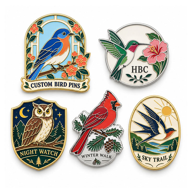 Five bird pin designs featuring a songbird, hummingbird, owl, cardinal, and swallow