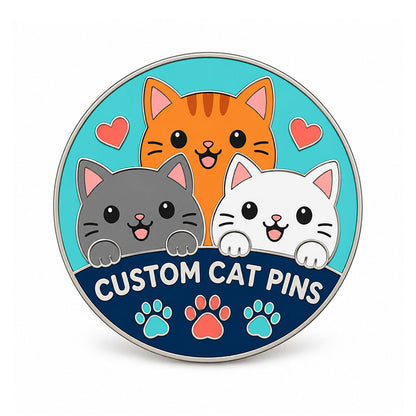 Round silver cat pin with three smiling cats, coral hearts, and teal paw details