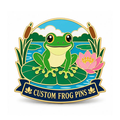 Gold frog pin with a green frog on a lily pad beside a pink lotus and pond reeds