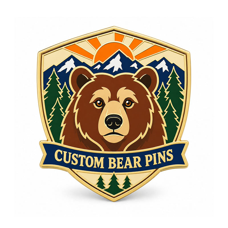 Gold bear pin with a brown bear portrait, mountain peaks, pine trees, and sunrise