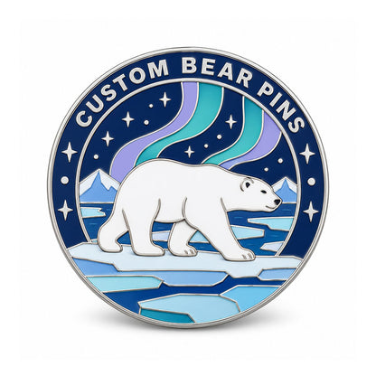 Round silver bear pin with a polar bear on sea ice beneath teal and lavender aurora