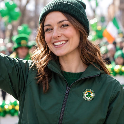 Woman wearing a round St. Patrick's Day pin on a green jacket at an outdoor parade