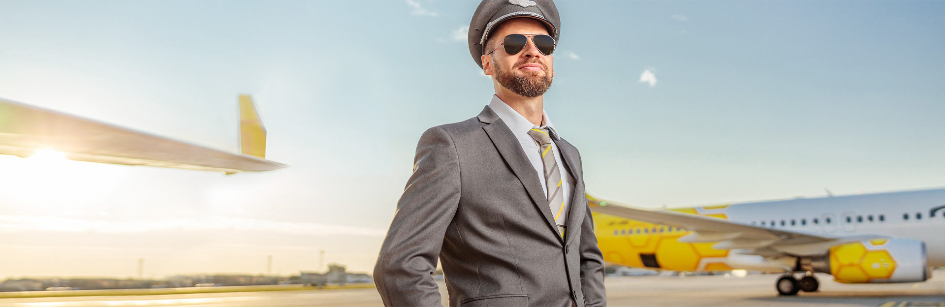 Airline Wing Pins Worn by Professional Airline Pilot in Front of Aircraft on Airport Tarmac for Professional Identity and Career Recognition