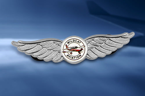 Custom Pilot Wing Pins For Aviation School Recognition Featuring Custom Text 'WILDCAT AVIATION' With Silver Stylized Wings And Circular Emblem On Sky-Themed Gradient Background