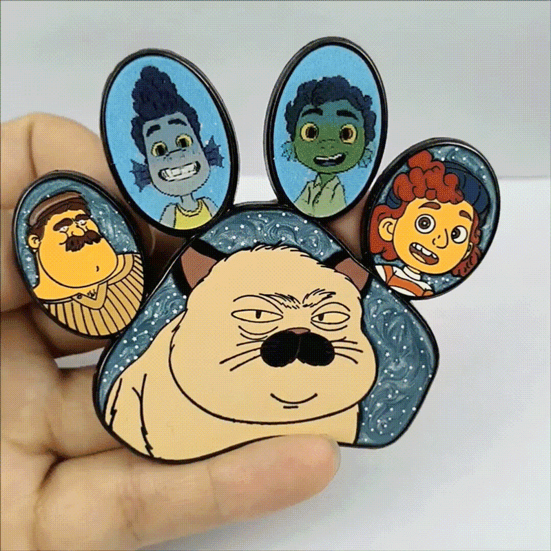 Custom lenticular enamel pin shaped like a cat paw, featuring a shifting multi-image design that displays different animated characters.