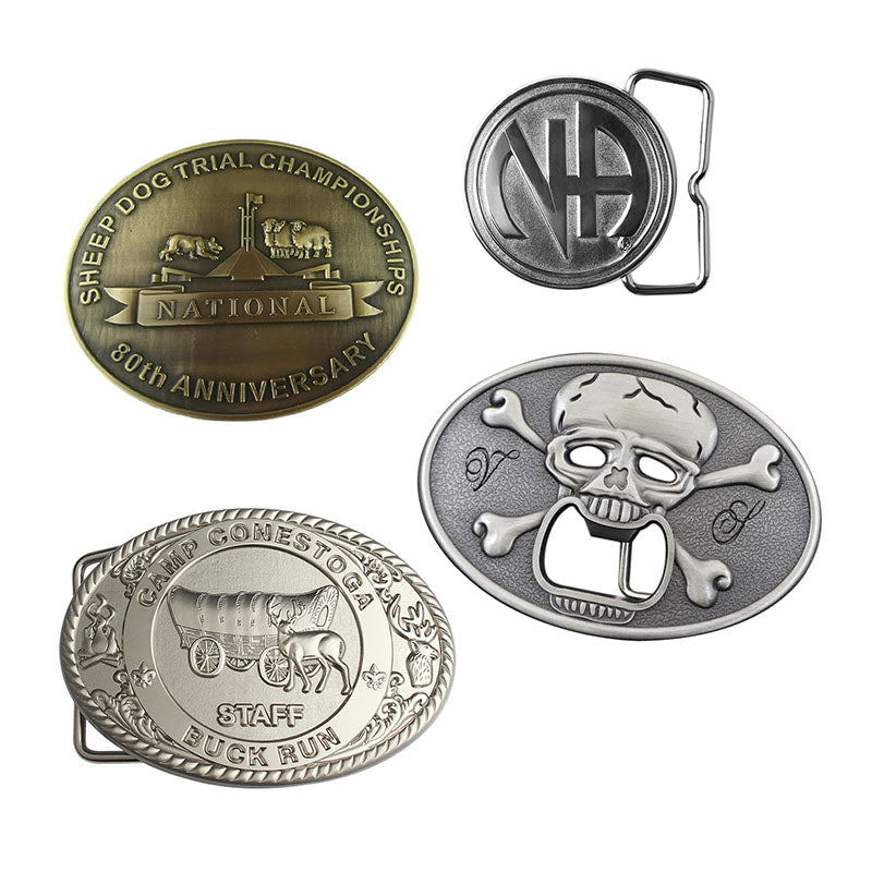 Display of four custom belt buckles with various designs including circular and oval shapes, featuring engraved custom text for personalization on a white background.