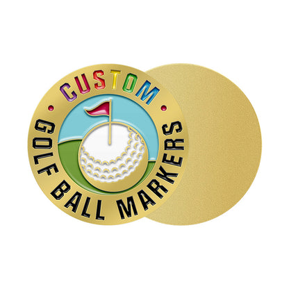 Gold custom golf ball marker with circular design, featuring custom text and a detailed golf scene including blue sky, green grass, a white golf ball with a red flag, along with a plain gold back