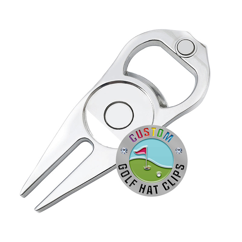 Silver multi-functional golf divot tool with integrated bottle opener and circular custom golf ball marker display featuring custom text, a red golf flag, white ball, and green background with small diamond accents