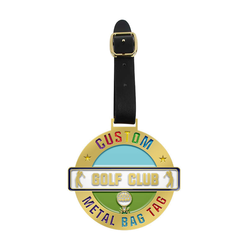 Custom golf bag tag with gold border, light blue and green areas featuring a golf ball motif and custom text, attached with black leather strap