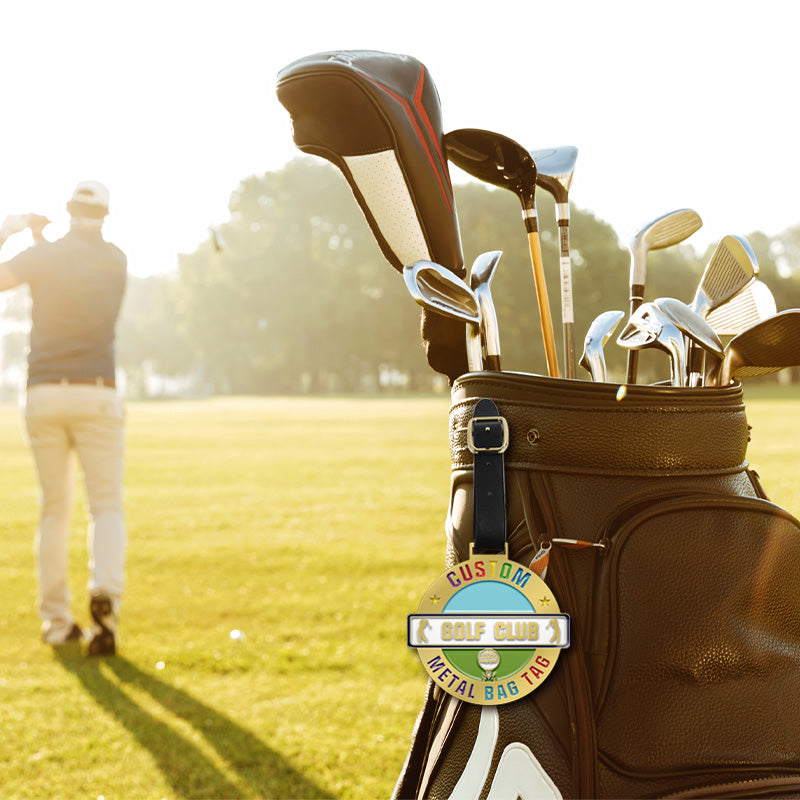 Personalized metal bag tag on a golf bag with clubs, designed for easy identification of golf gear during course play.