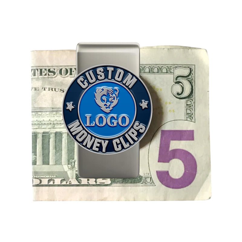 Custom silver money clip with circular blue enamel emblem, featuring custom text, an animal head design, and white stars, displayed clipping a US $5 bill.