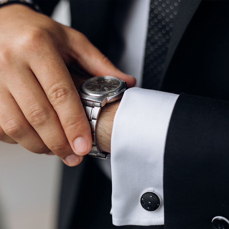 Professional gentleman preparing for an important event, wearing personalized cufflinks.
