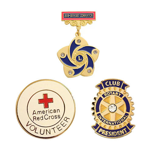 Set of three pins featuring American Red Cross Volunteer, Lion's Club, and Rotary International logos