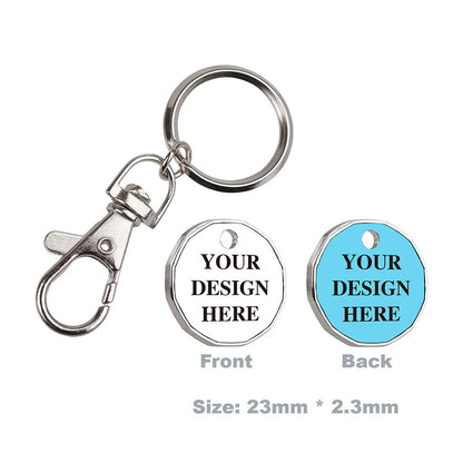 Diagram showing front and back of a personalized trolley coin keychain with silver clasp, white front and light blue back featuring placeholder text for adding logos and text, dimensions 23mm x 2.3mm.