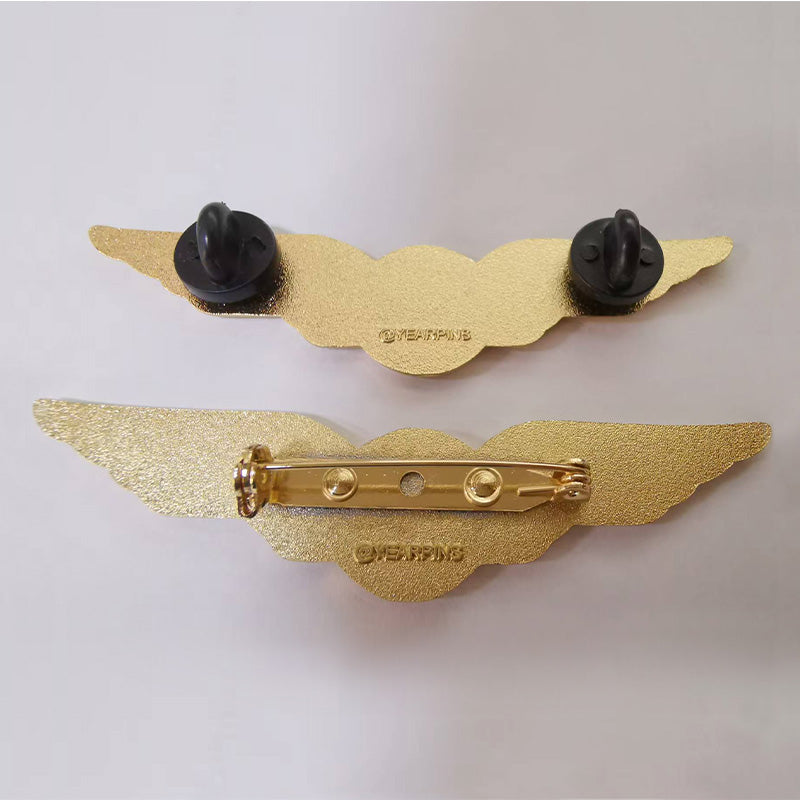 Back attachment of pilot wings pin with logo, including 2 rubber clutches or a safety pin, and the back stamp is Yearpins
