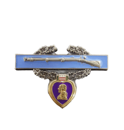 Custom purple heart veteran lapel pin featuring a silver rifle on blue rectangular base, laurel wreath, heart-shaped medal with George Washington portrait, small shield with stars and stripes, and custom text.