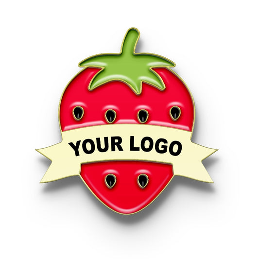 A pin badge designed with a red strawberry shape, green leaves, and a placeholder for a custom logo in a ribbon banner.